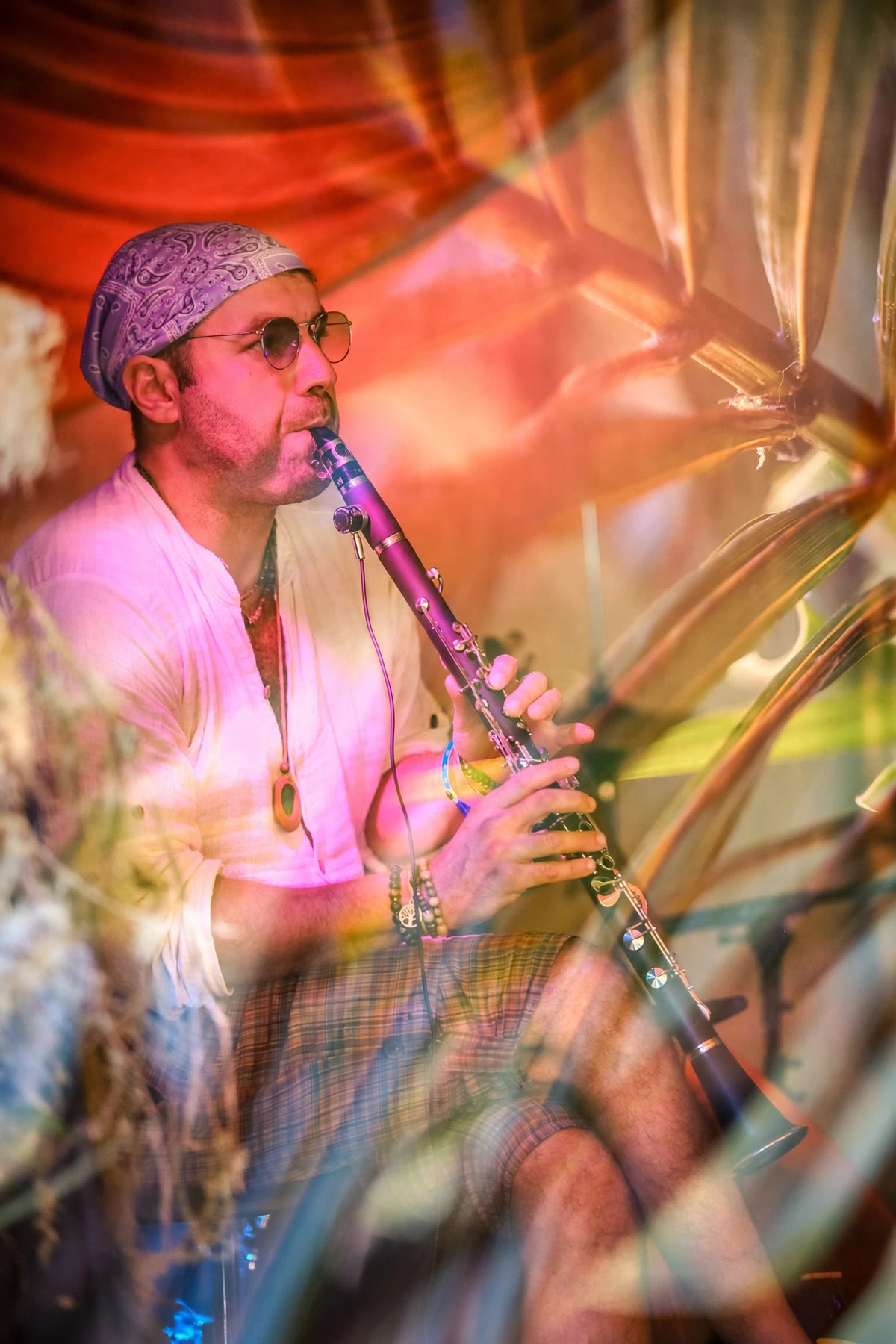 Playing the G clarinet on stage under red drapes